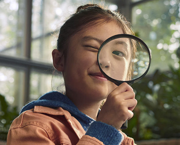 Child with a magnifying glass